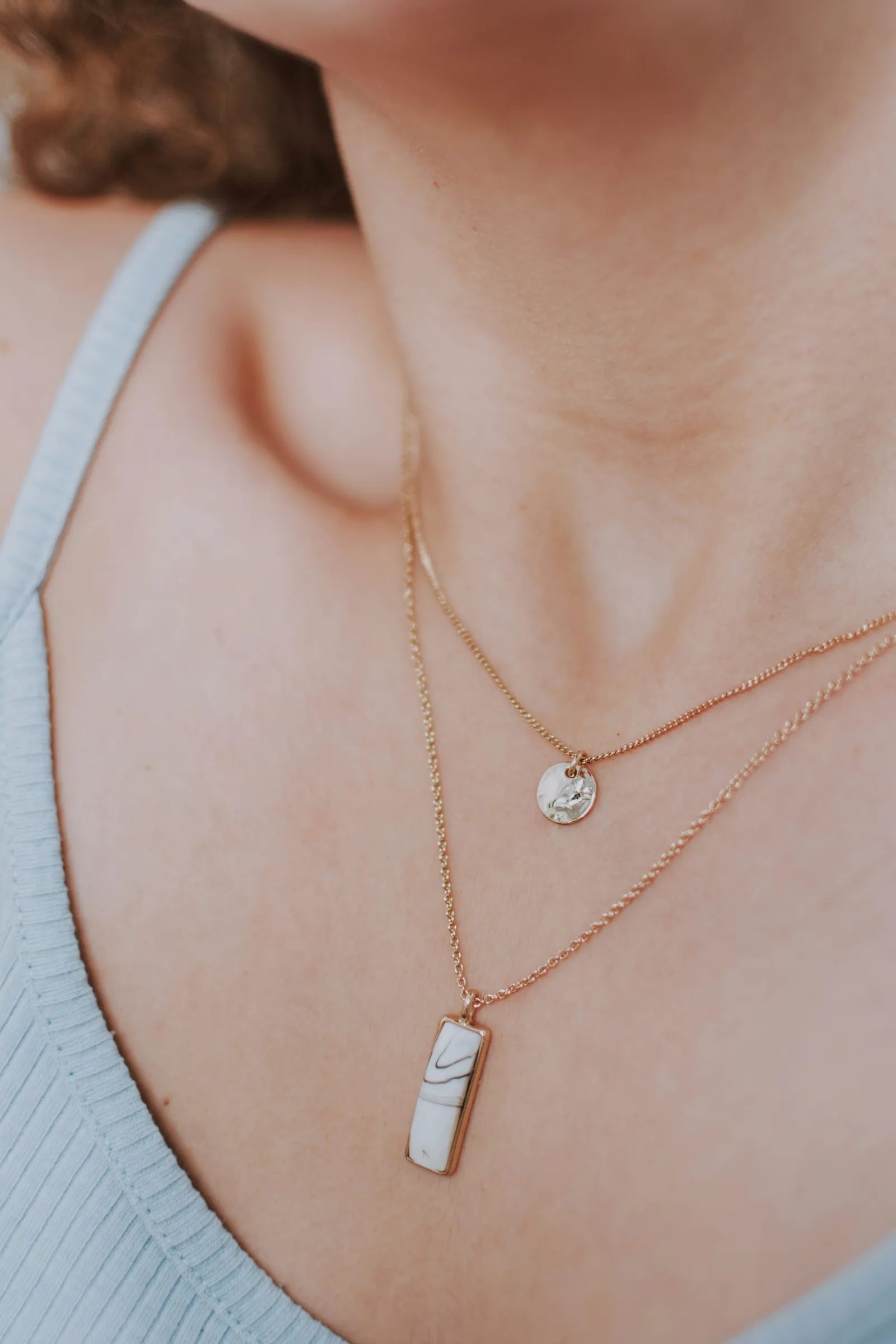 A close view of a handmade pendant catching soft window light.
